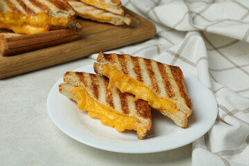 Concept of tasty eating with grilled sandwiches on white textured table