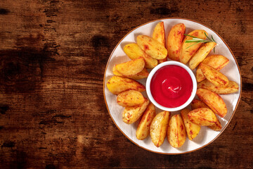 Baked potato wedges on a plate, shot from above