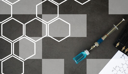 small jars with injection and syringe for injection on a blue background near the chemical formula