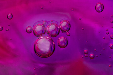 Liquid art background with oxygen bubbles. Abstract textured neon background of slime. Macro photo...