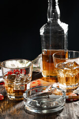 Playing poker with whiskey and cigars on table