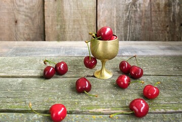 red cherries on the wooden table