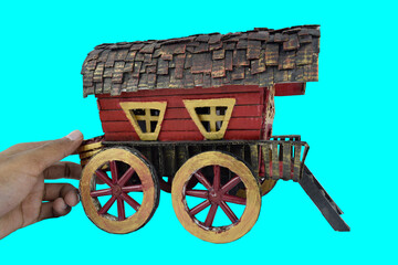 One red colored paper crafted horse carriage on an empty Green paper background