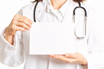 Female doctor holding a blank poster board with both hands. Health concept