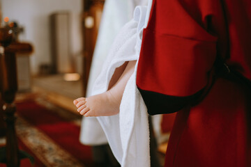 a baby's foot during a baptism ceremony in a Christian church