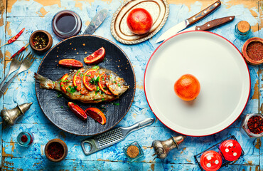 Baked dorada in orange sauce.