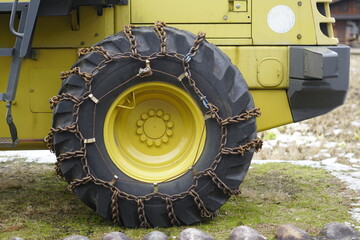 Tractor wheels. The tractor wheels are wrapped with chains for good use in tough conditions. can be used in agriculture