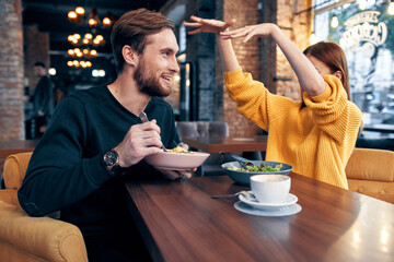 cheerful young couple in a restaurant having a snack rest lifestyle
