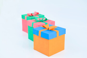 Person holding a lid of a hand made paper crafted gift box of orange color