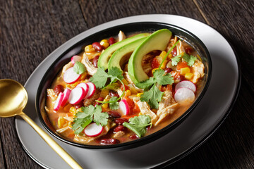 Mexican chicken and tortilla soup on a black plate