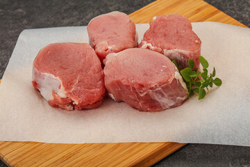 Raw pork medallion served rosemary