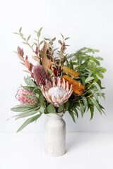 Beautiful floral arrangement of mostly Australian native flowers, including king protea, banksia,...