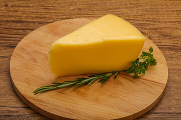 Hard cheese piece served rosemary