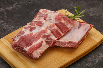 Raw pork ribs served rosemary