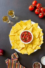 Corn chips nachos with salsa dip. Mexican food. Vegetarian food.