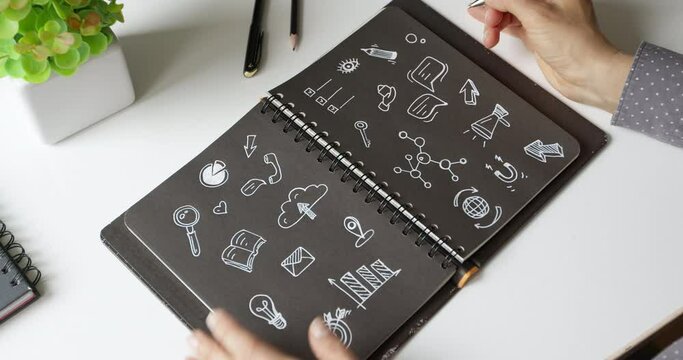 Digital marketing concept. Business woman is drawing a planning strategy in a notebook.