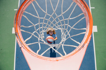 Top view of kid playing basketball with basketball ball. © Volodymyr