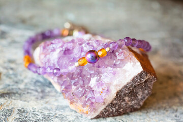 Amethyst and hematite mineral stone bracelet on natural background