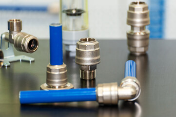 Hosepipe fittings on the table.  Pipeline spare parts.