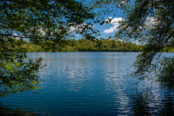 Obraz premium The view of the Weinfelder Maar on a sunny spring day