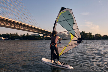 Naklejka premium Windsurfer surfing on a windy day at the river.