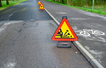 warning signs on road and cycle path