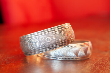 Indian silver bracelets on the shiny surface