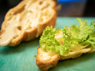 cut croissant with salad