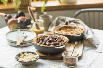 Plum and apple tart on the kitchen on the table with linen tablecloth, summer tart