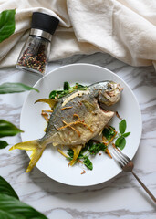 The plate of fried pomfret on the table
