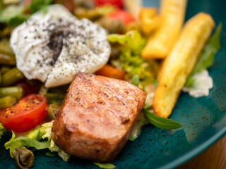 salad with meat, eggs and fries