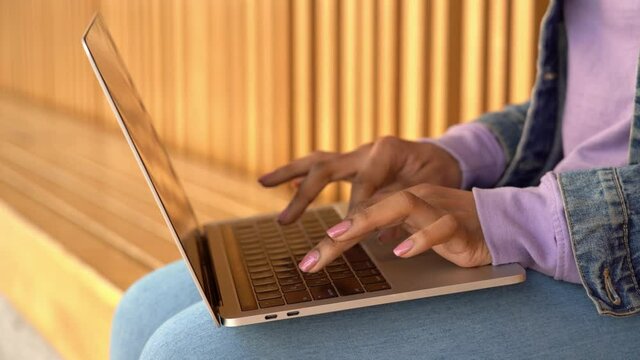 Woman hands typing using laptop computer, working online sitting at workplace 