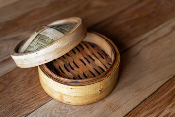 Bamboo steamer set, chinese kitchenware on wooden table, top view. Empty traditional asian bamboo...