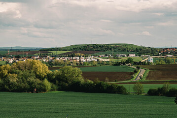 view from the hill to a small Czech village, summer landscape with green fields