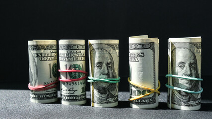 US dollars bundle close up isolated on dollar background. Paper denominations of dollars cash rolls...