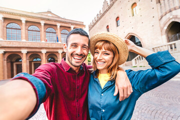 Young boyfriend and girlfriend in love having fun taking selfie at old town tour - Wanderlust life...
