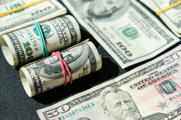 US dollars bundle close up isolated on dollar background. Paper denominations of dollars cash rolls...
