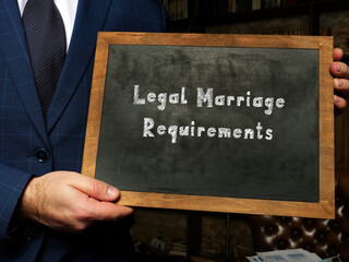 chalkboard in a hand with phrase Legal Marriage Requirements . Horizontal shot. Close-up