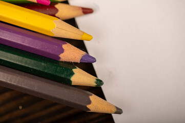 Obraz premium Colored pencils on a wooden table. Close-up, selective focus.
