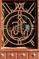 Wooden door with anchor detail in wrought iron