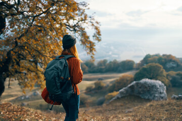 woman hiker backpack in travel mountains autumn lifestyle