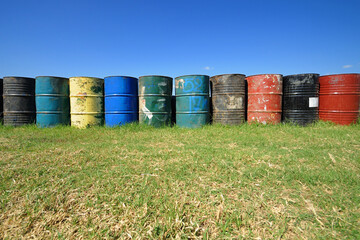 Obraz premium Colorful used old oil drums on the grass