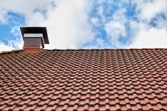 brown tiled roof, chimney and the sky