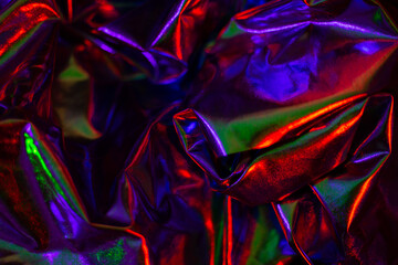 abstract iridescent dark metallic texture with vibrant neon colors 