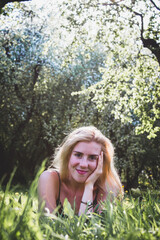 Obraz premium sunny girl in a blooming park