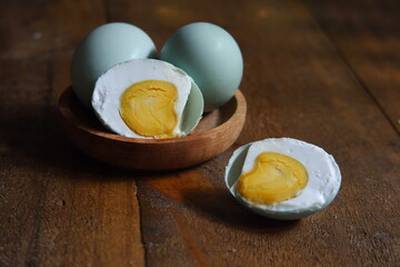 salted egg slices on a wooden table