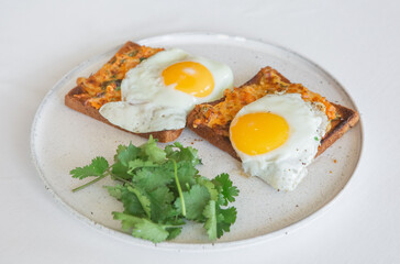 scrambled eggs toast melted cheese cilantro plate