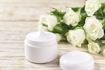 Moisturizing cream for sensitive skin,  spa cosmetic and natural clean skincare product on a background of white roses.