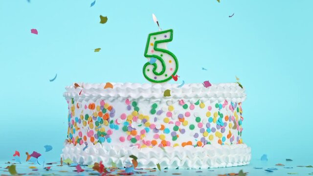 Birthday Cake With Burning Colorful Candle with Number 5 on Pastel Background. Falling confetti. Super Slow Motion, 1000 FPS.