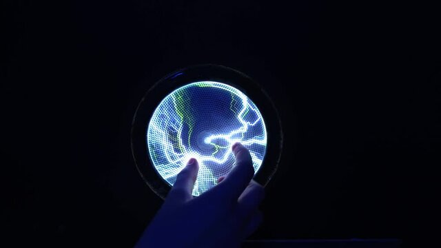 Abstract science background and object, electric lighting. Hand touching plasma panel display. Lightning blue